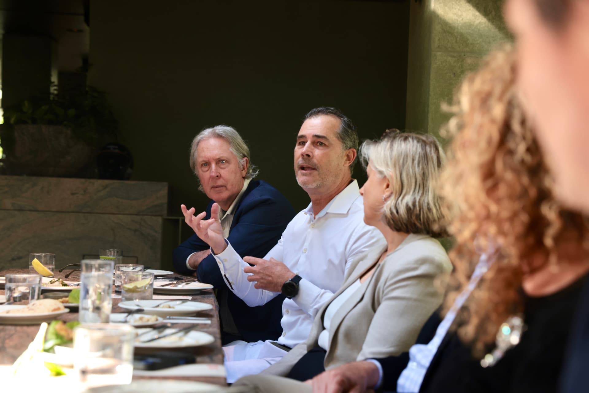 Three participants listening as an argument is put to the table