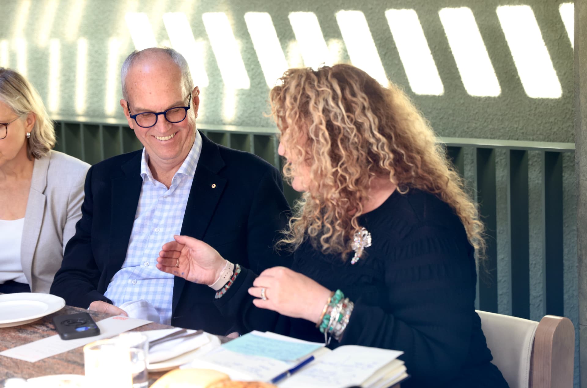 Two participants sharing a laugh partway through the Brisbane lunch